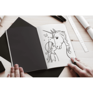 a person drawing a unicorn on a book
