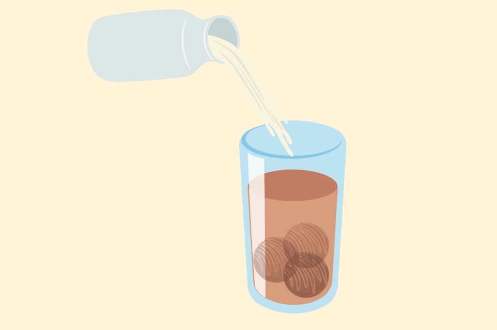 Pour the warm milk slowly over the hot chocolate bomb